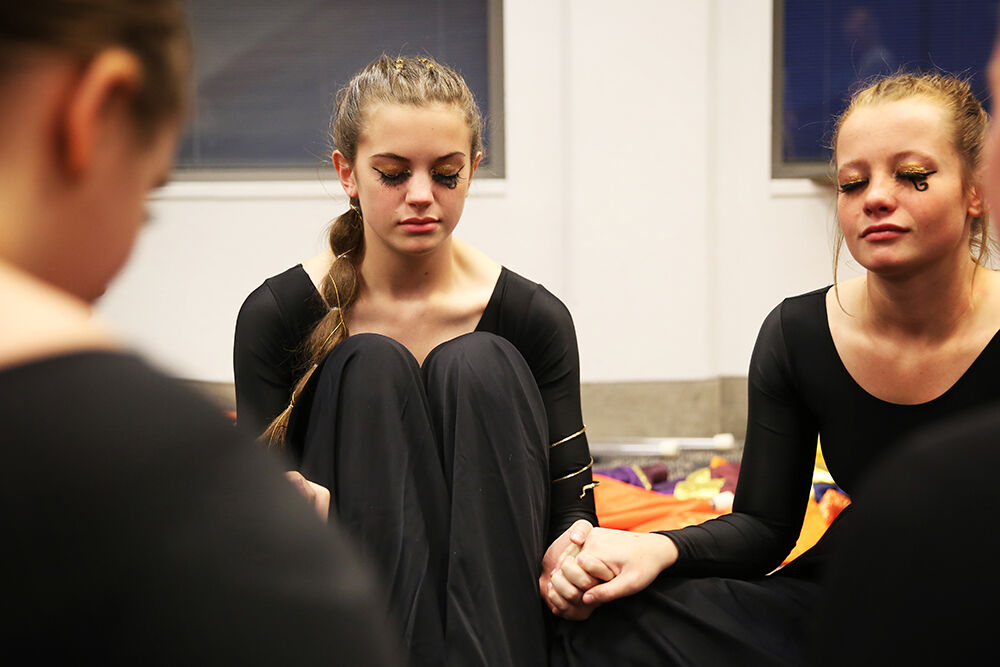 Madison Bartlett joins hands with the rest of the guard
